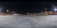 a skateboarder at the top of an empty ramp at night in the city