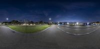 a 360 - angle view of the sky and buildings in the background, at night