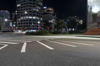 a night view of buildings and street lights, with a traffic light in the middle