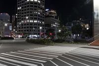 a night view of buildings and street lights, with a traffic light in the middle