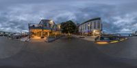 a view from a fish eye lens of a hotel on the edge of water near some buildings