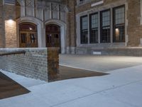 a fire hydrant is set up by the curb on an empty building side walk