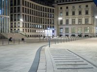 a row of buildings and walkways at night in the city square of vienna, germany