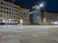 the square is empty and empty at night in an old city square with a building behind it