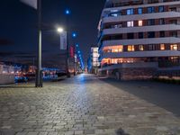 a long narrow cobble stone walkway in the middle of a building next to a street