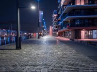 a long narrow cobble stone walkway in the middle of a building next to a street