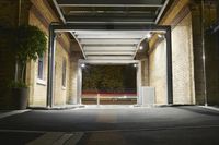 the building has an open area at night with no traffic on the road or in motion