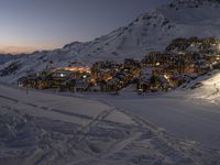 a view of the mountain village of an outdoor ski area on a very snowy day