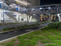 a view of a road and an overpass with traffic passing through it by buildings