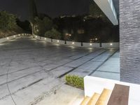 an outdoor patio with steps leading to steps leading up the hill and onto the street