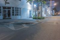 a street with a cross walk that has no one walking on it while a person is crossing the road and an empty sidewalk is visible