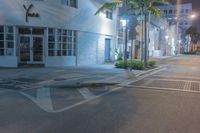a street with a cross walk that has no one walking on it while a person is crossing the road and an empty sidewalk is visible