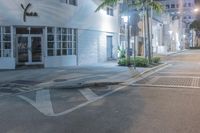 a street with a cross walk that has no one walking on it while a person is crossing the road and an empty sidewalk is visible