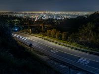 Night Overlook of Los Angeles Cityscape with Modern Architecture and Elevated Road