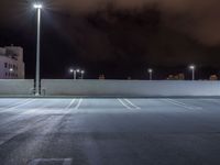 a parking lot is illuminated with several different lights over the top of it, which can be seen here at night