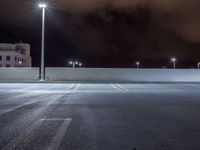 a parking lot is illuminated with several different lights over the top of it, which can be seen here at night