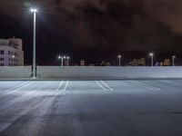 a parking lot is illuminated with several different lights over the top of it, which can be seen here at night