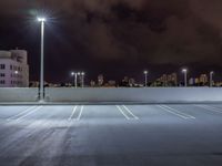 a parking lot is illuminated with several different lights over the top of it, which can be seen here at night