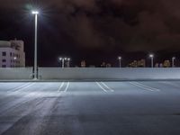 a parking lot is illuminated with several different lights over the top of it, which can be seen here at night