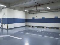 a garage with some parking spaces painted grey blue and white with some cars parked in the middle