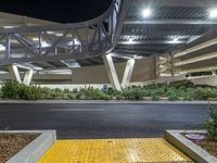 a view of a road and an overpass with traffic passing through it by buildings