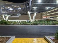 a view of a road and an overpass with traffic passing through it by buildings