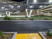 a view of a road and an overpass with traffic passing through it by buildings