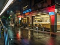 a store with food sits on the street at night in tokyo, japan, asia