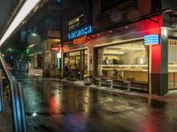 a store with food sits on the street at night in tokyo, japan, asia