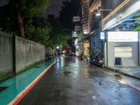 the wet road is lined with parked motorcycles and scooters in the rain at night