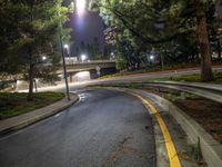 a night time photo of a street and a highway at night with a yellow stripe