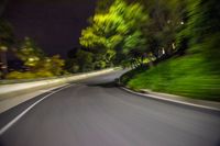 an extreme blurry image of a road at night, driving on the side of the road