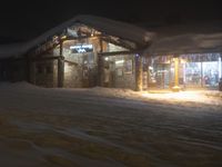 Night Road with Snow Covered Building