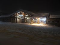 Night Road with Snow Covered Building