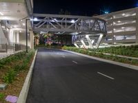 a view of a road and an overpass with traffic passing through it by buildings