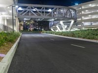 a view of a road and an overpass with traffic passing through it by buildings