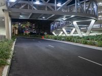 a view of a road and an overpass with traffic passing through it by buildings