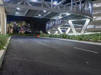 a view of a road and an overpass with traffic passing through it by buildings