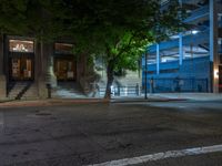 a city street at night with parking meters on either side and the road in the center