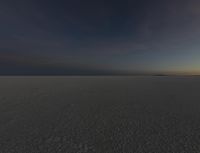 a photo of an empty field with no clouds in it, taken at sunrise time