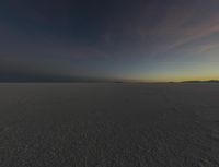 a photo of an empty field with no clouds in it, taken at sunrise time