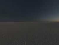 a photo of an empty field with no clouds in it, taken at sunrise time