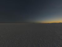 a photo of an empty field with no clouds in it, taken at sunrise time