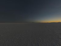 a photo of an empty field with no clouds in it, taken at sunrise time