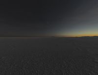 a photo of an empty field with no clouds in it, taken at sunrise time