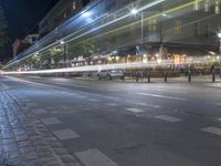 this is an image of a night scene on the street of a city with traffic in motion