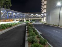 a view of a road and an overpass with traffic passing through it by buildings