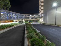 a view of a road and an overpass with traffic passing through it by buildings