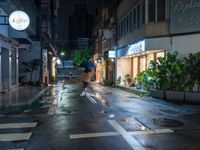 an empty wet city street at night during the day time with rain pouring on the ground