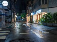 an empty wet city street at night during the day time with rain pouring on the ground